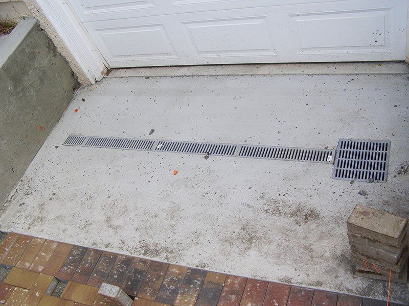 A newly installed California drain for driveway drainage