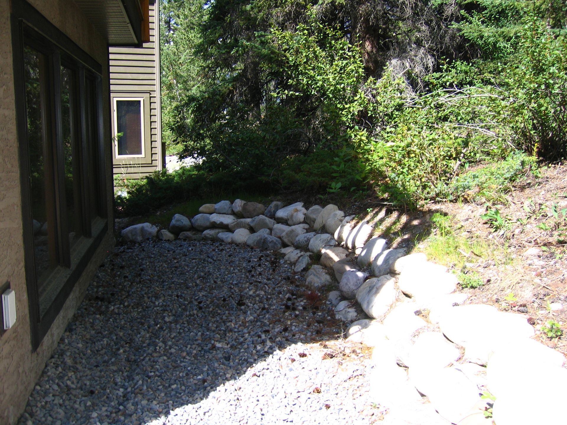 A new drain rock and French drain system installed for residential home