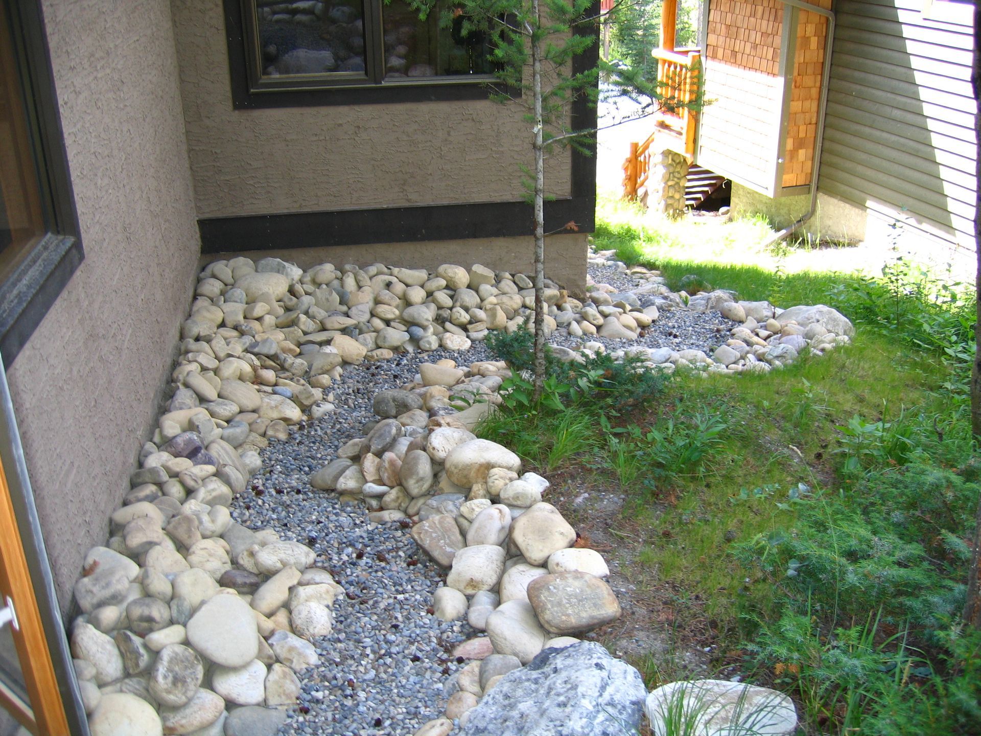 A curtain drain interception trench wrapping around perimeter of Victoria BC home