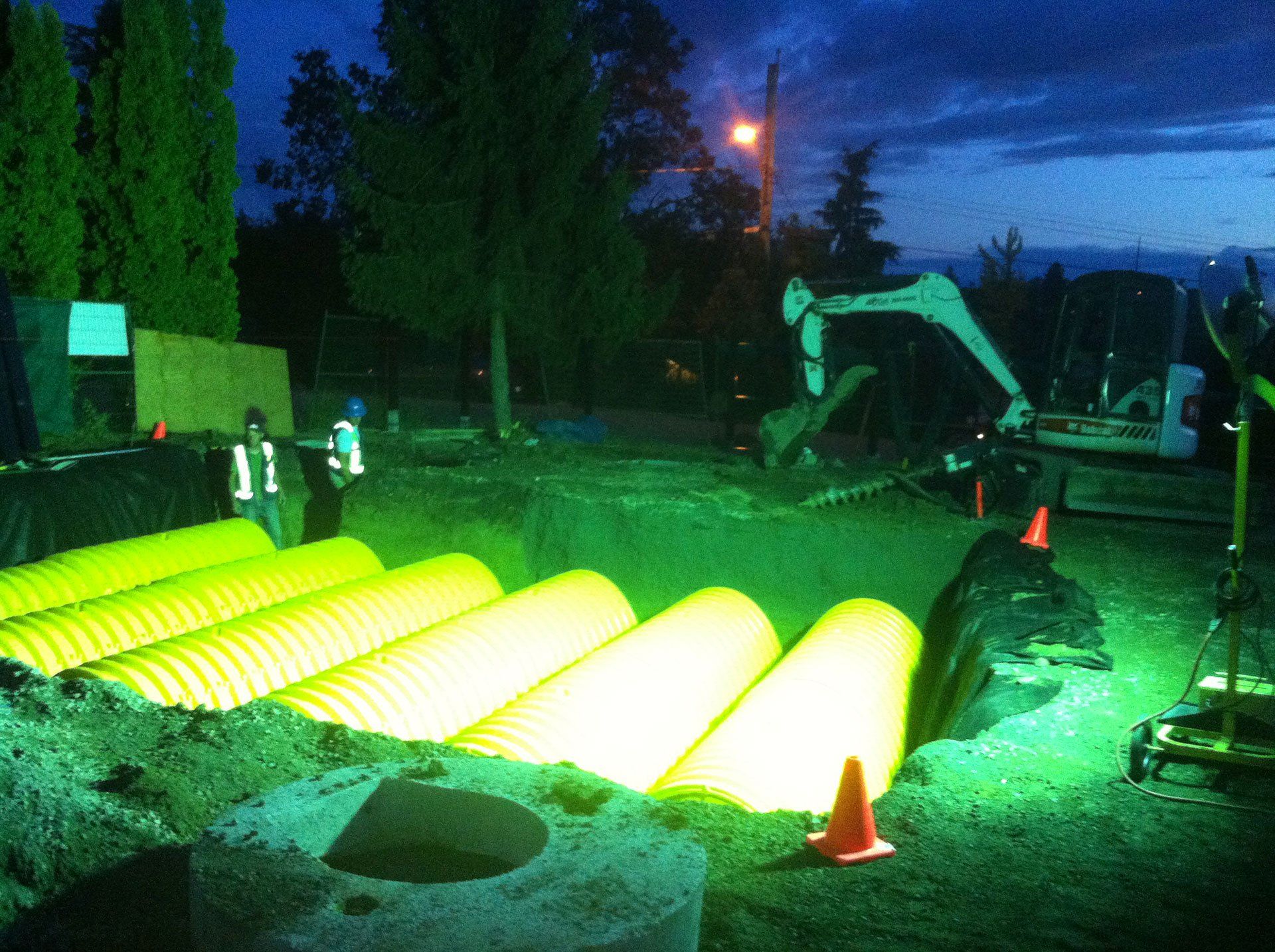 RainTek workers working late into the night into install large rainwater harvesting system