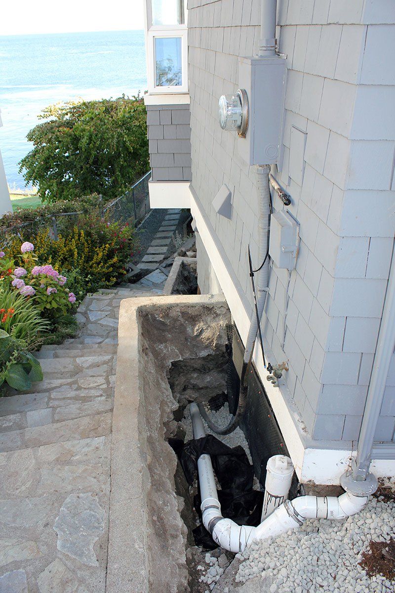 Newly installed drain pipe to replace old weeping tile