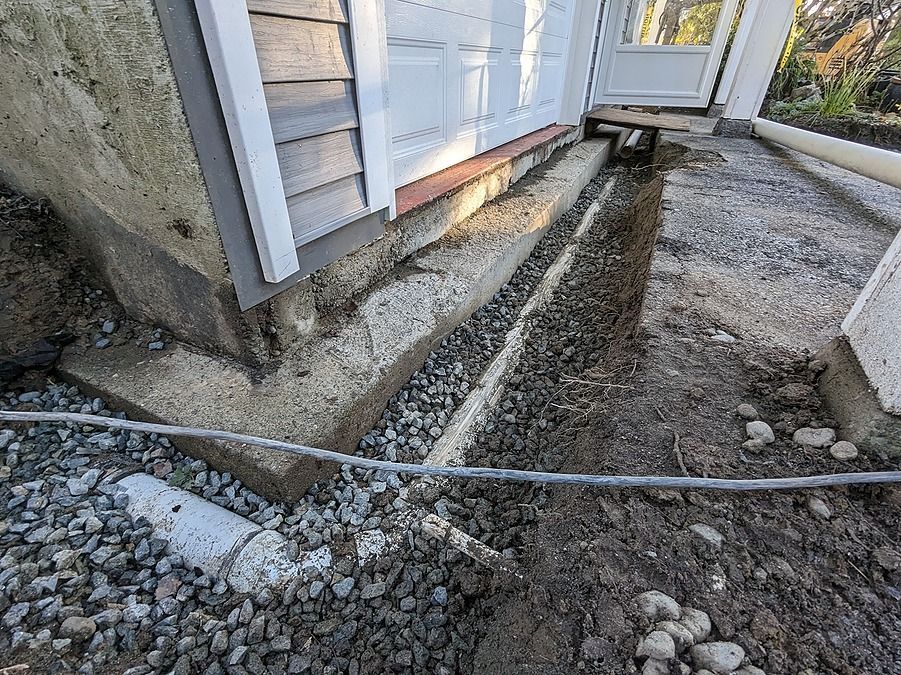 PVC drain pipe around the perimeter of a home's foundation in Saanich, British Columbia, Canada