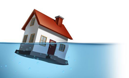 An illustration of a house sinking in water to symbolize how it feels to have a drain tile and a perimeter drain system that isn't working correctly