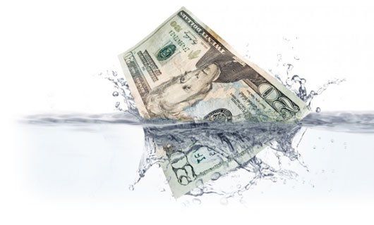 Money falling into water to symbolize the money pit some people fall into when they don't hire professional drainage contractors