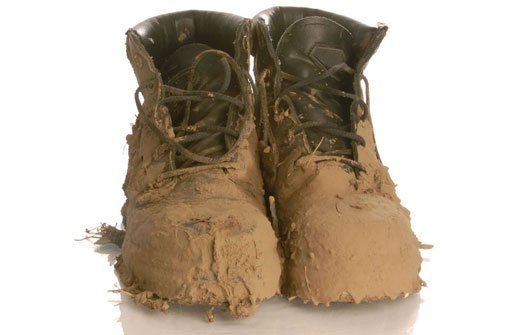 Muddy boots caused by stepping through swamped lawn due to lack of proper drainage