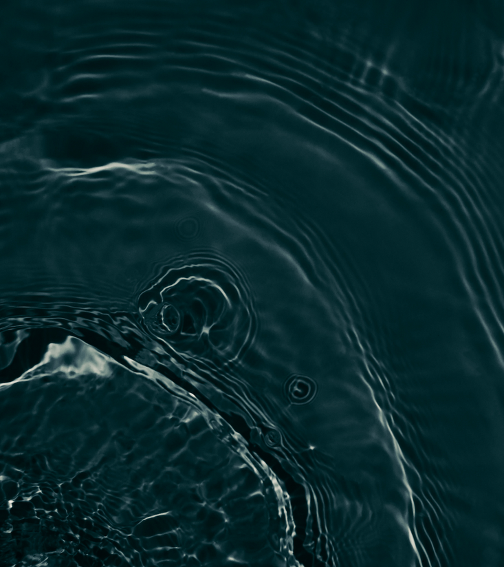 A close up of a dark blue water surface