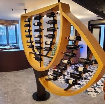 Yellow wine rack holding numerous bottles in a modern restaurant setting.