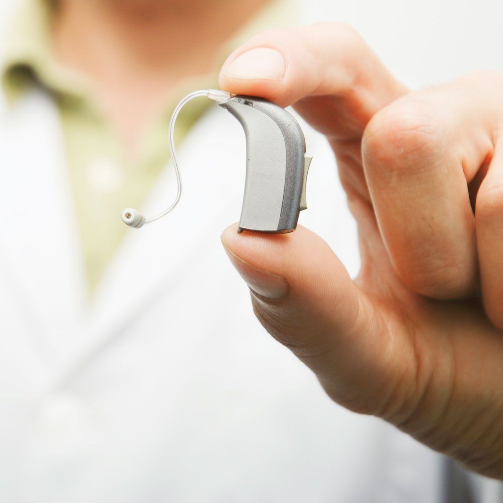 Holding an Hearing Aid — St. Paul, MN — Jackson Medical Equipment