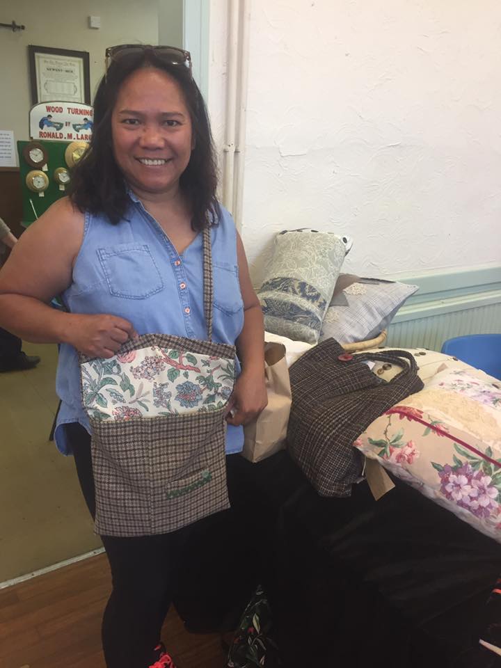lady holding baskets of craft items for sale