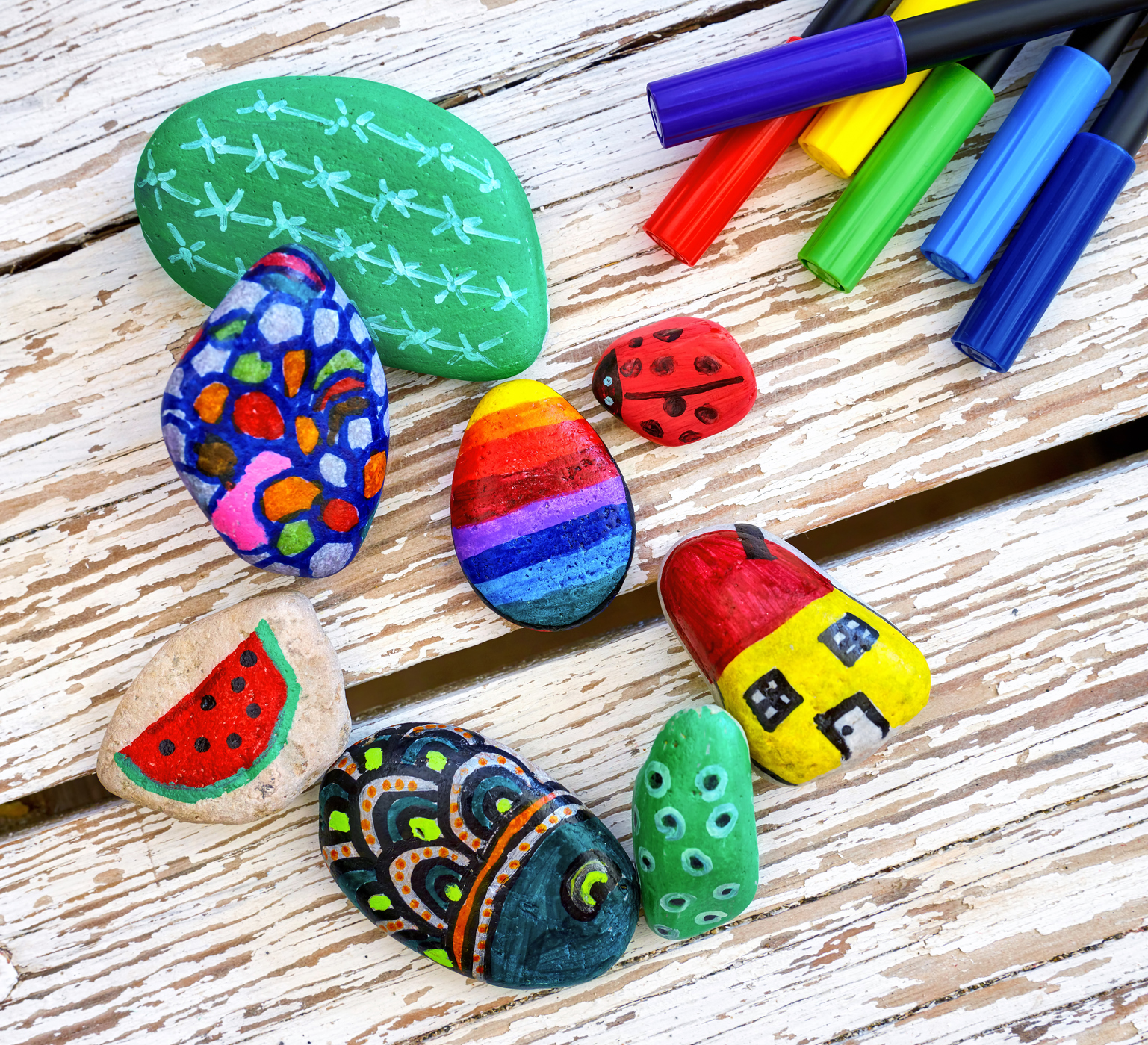 painted craft stones on table