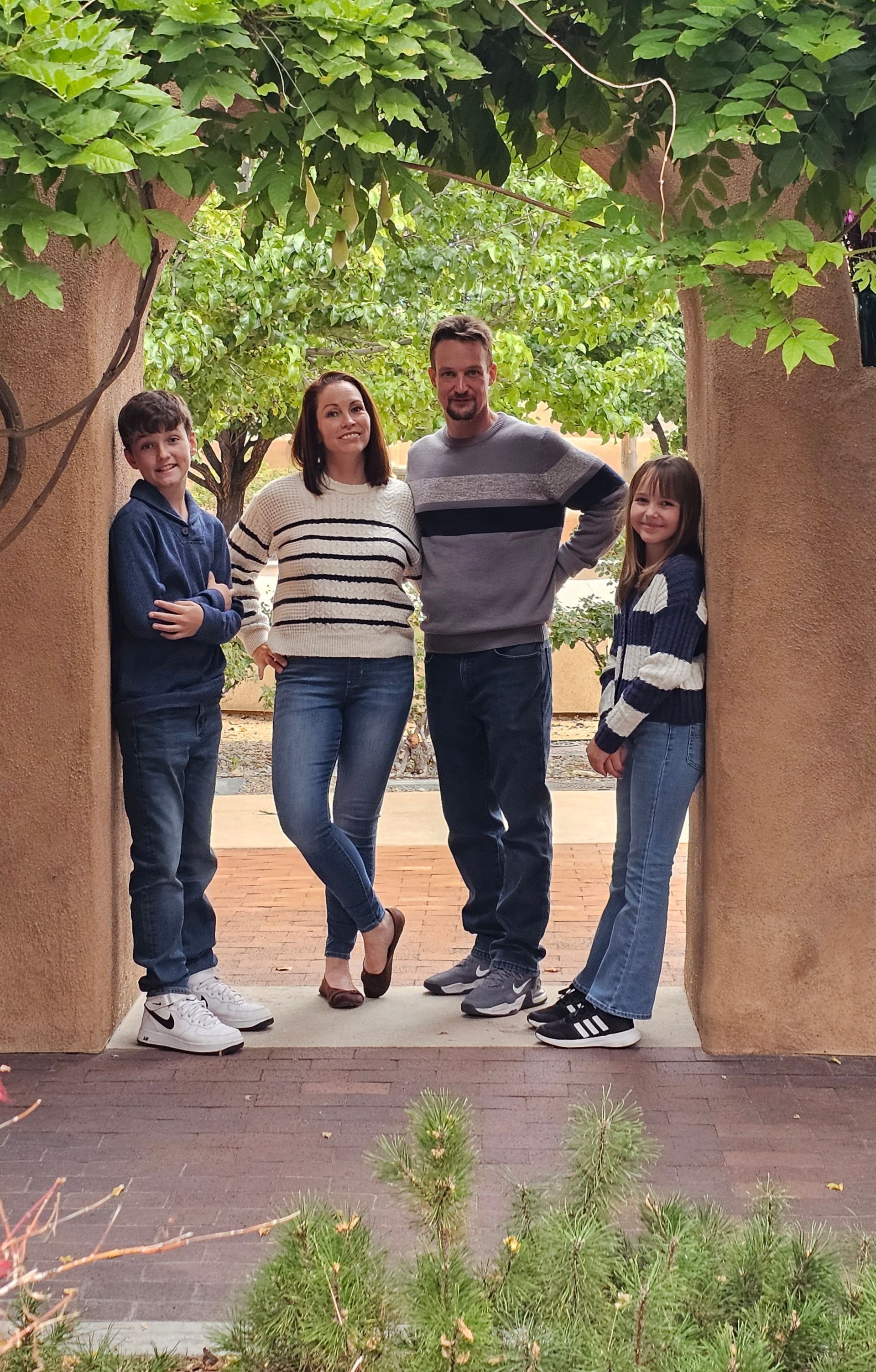 a family is posing for a picture in a doorway .