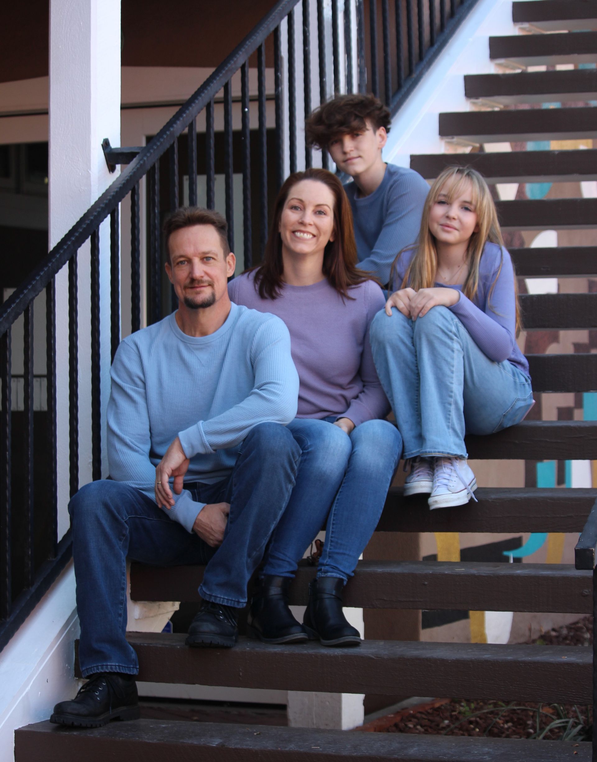 a family is posing for a picture in a doorway .