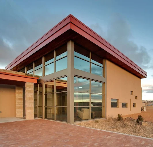 French Funerals & Cremation Rio Rancho funeral home, modern building with two-story glass entry, hosting cremation with memorial