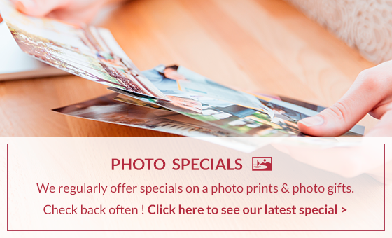 A person is holding a piece of paper that says photo specials