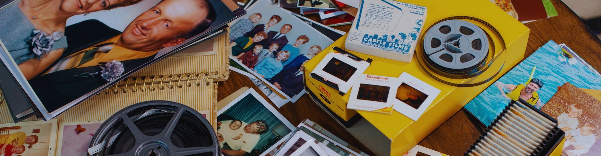 A bunch of pictures and a film reel on a table