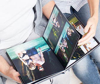Two Persons Looking at Photo Book