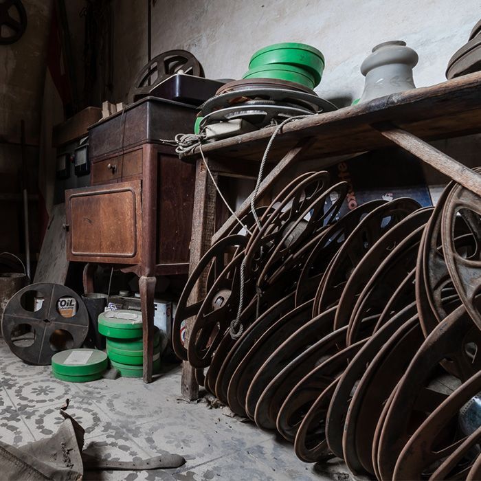 A bunch of old wheels are stacked on top of each other