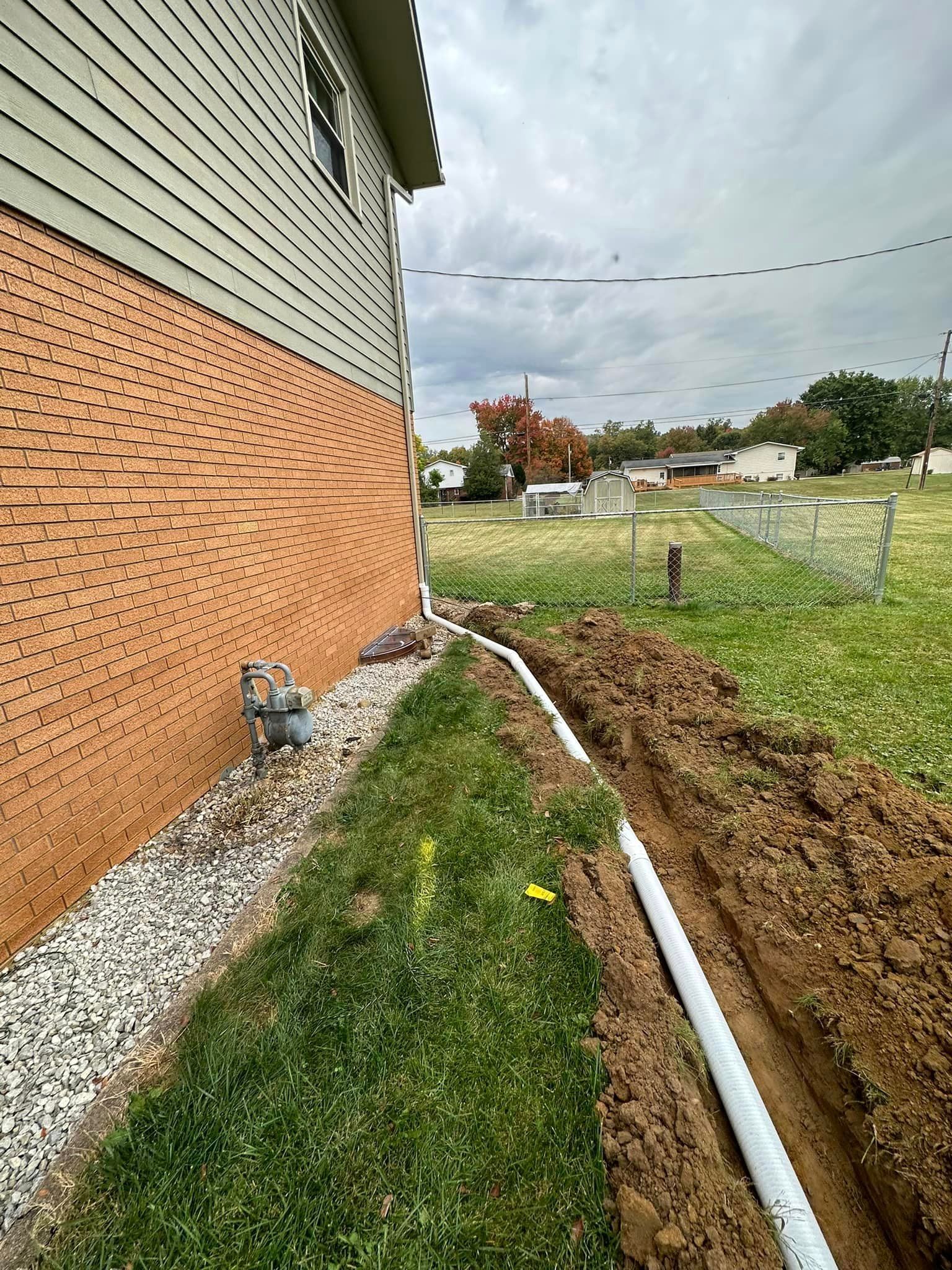 a hose is being installed on the side of a house .