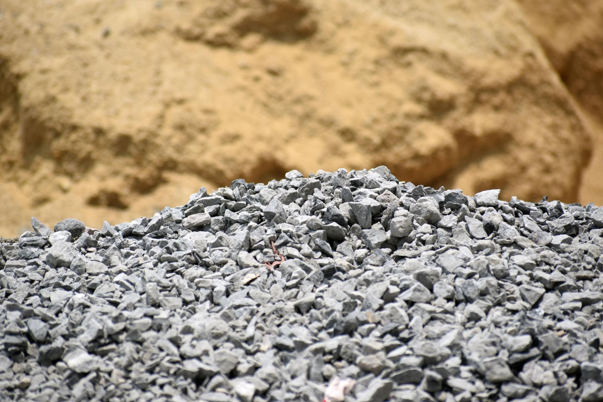 a pile of gravel is sitting next to a pile of sand .