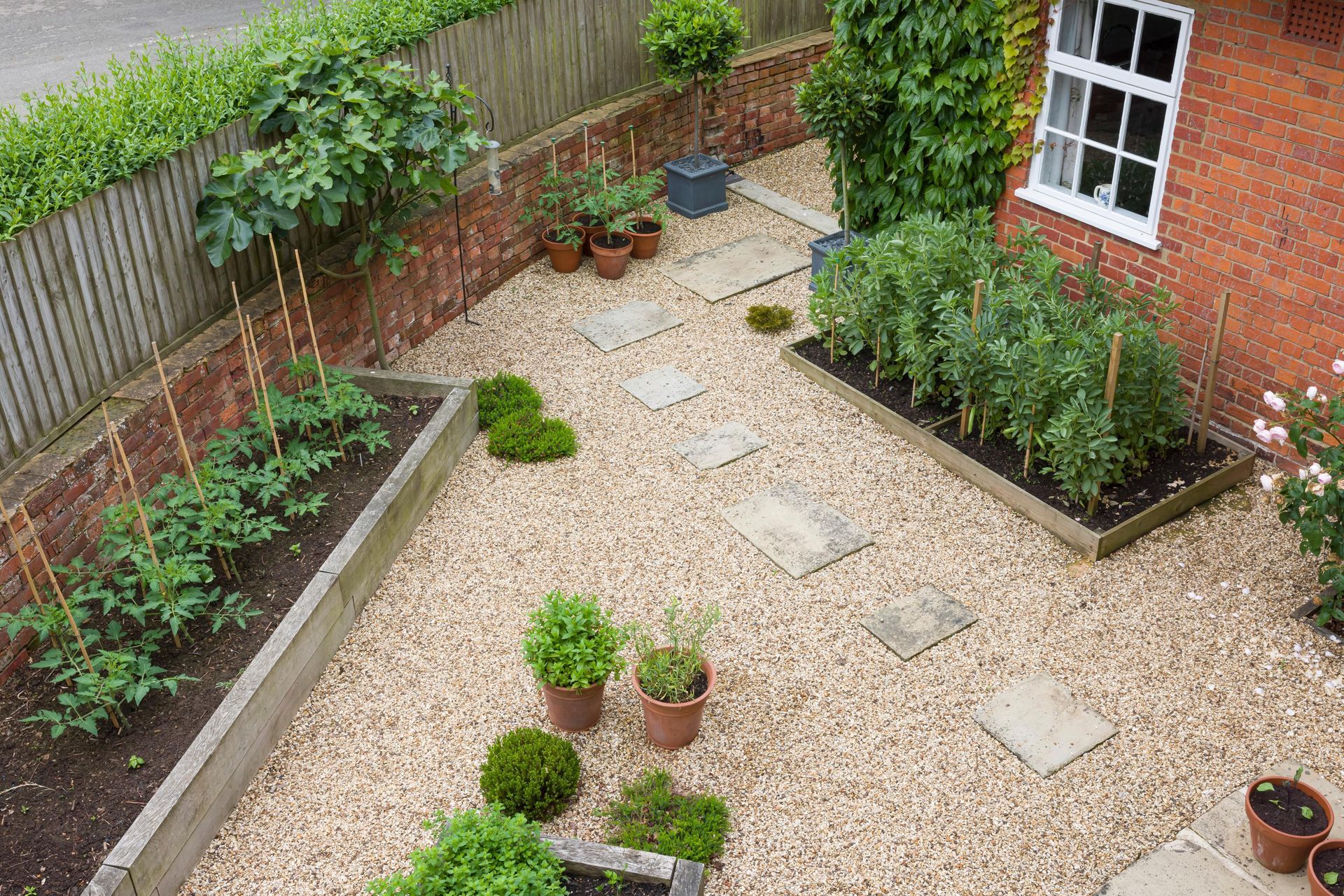 an aerial view of a garden with potted plants and gravel .