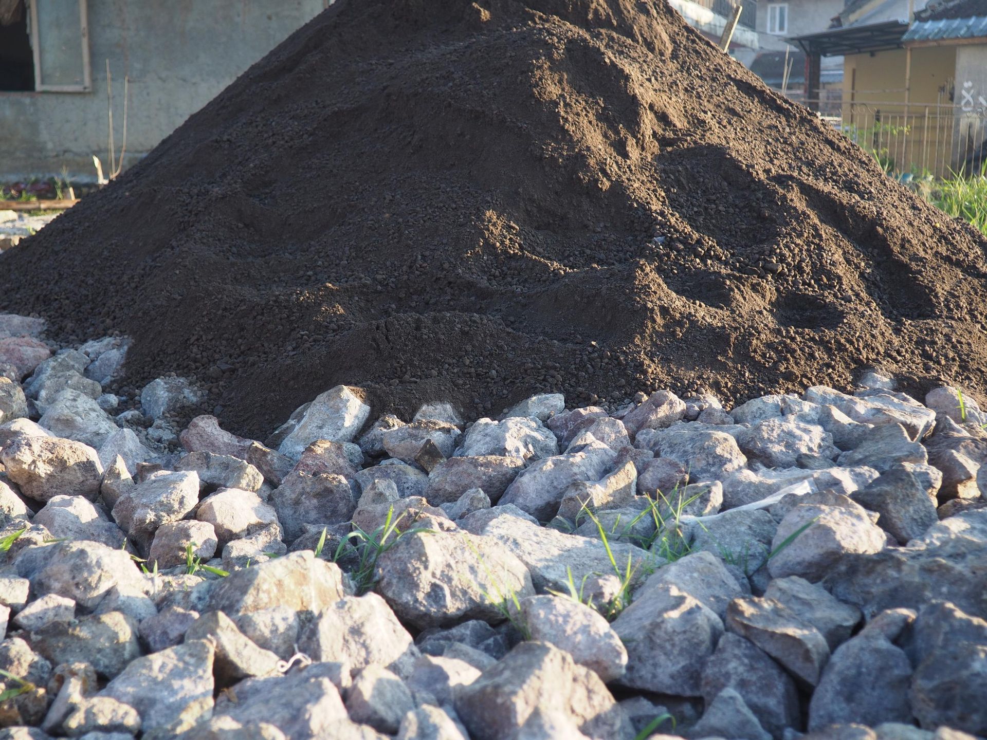 a pile of dirt sits on top of a pile of rocks