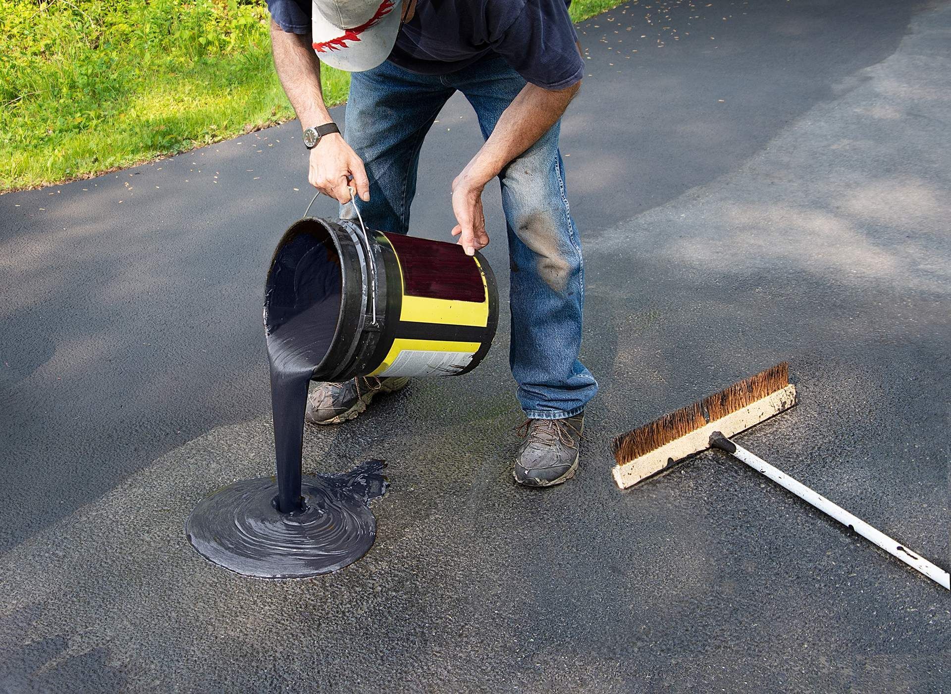 man pouring asphalt grease