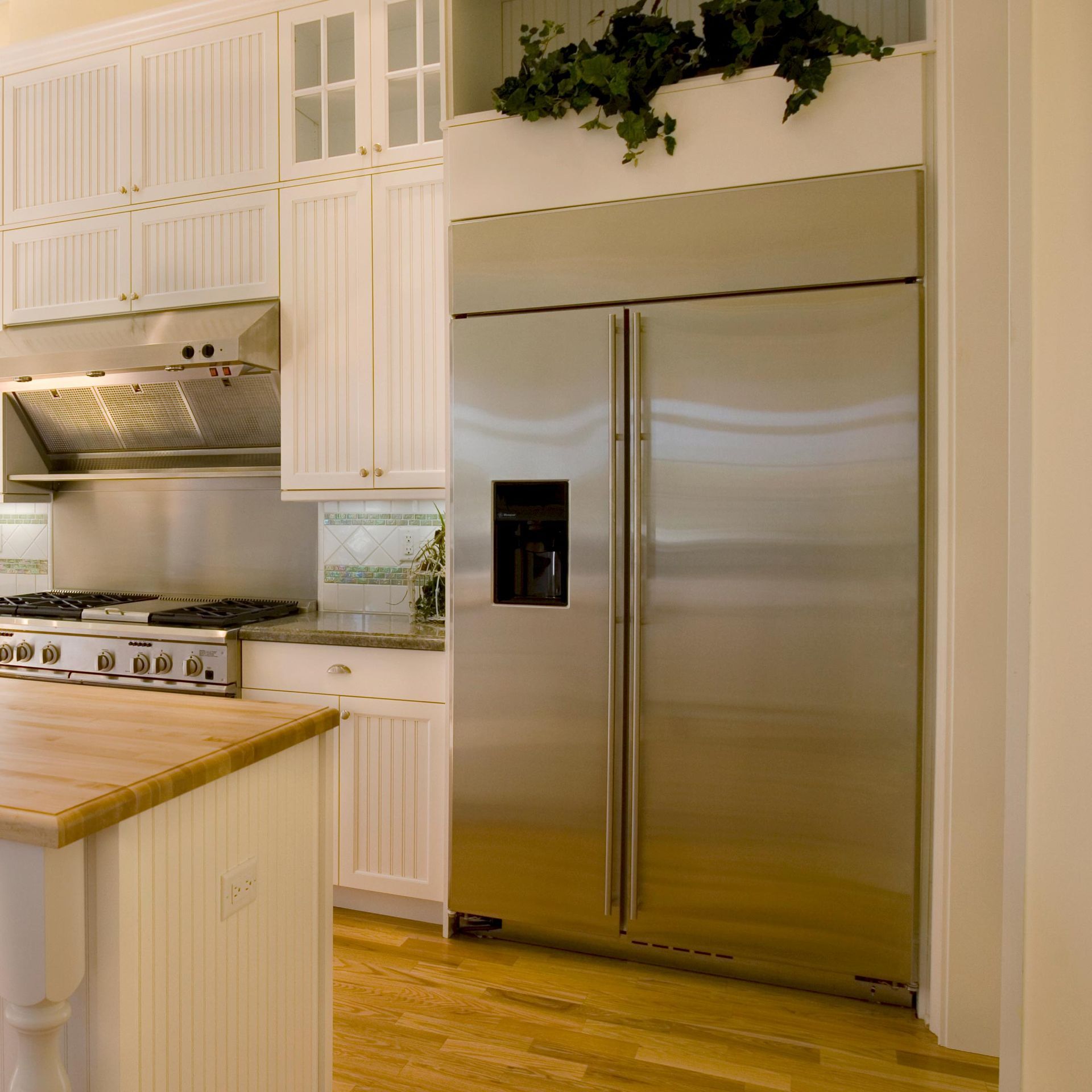 A kitchen with stainless steel appliances and white cabinets