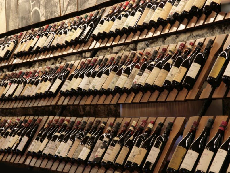 Wine rack full of bottles of red wine