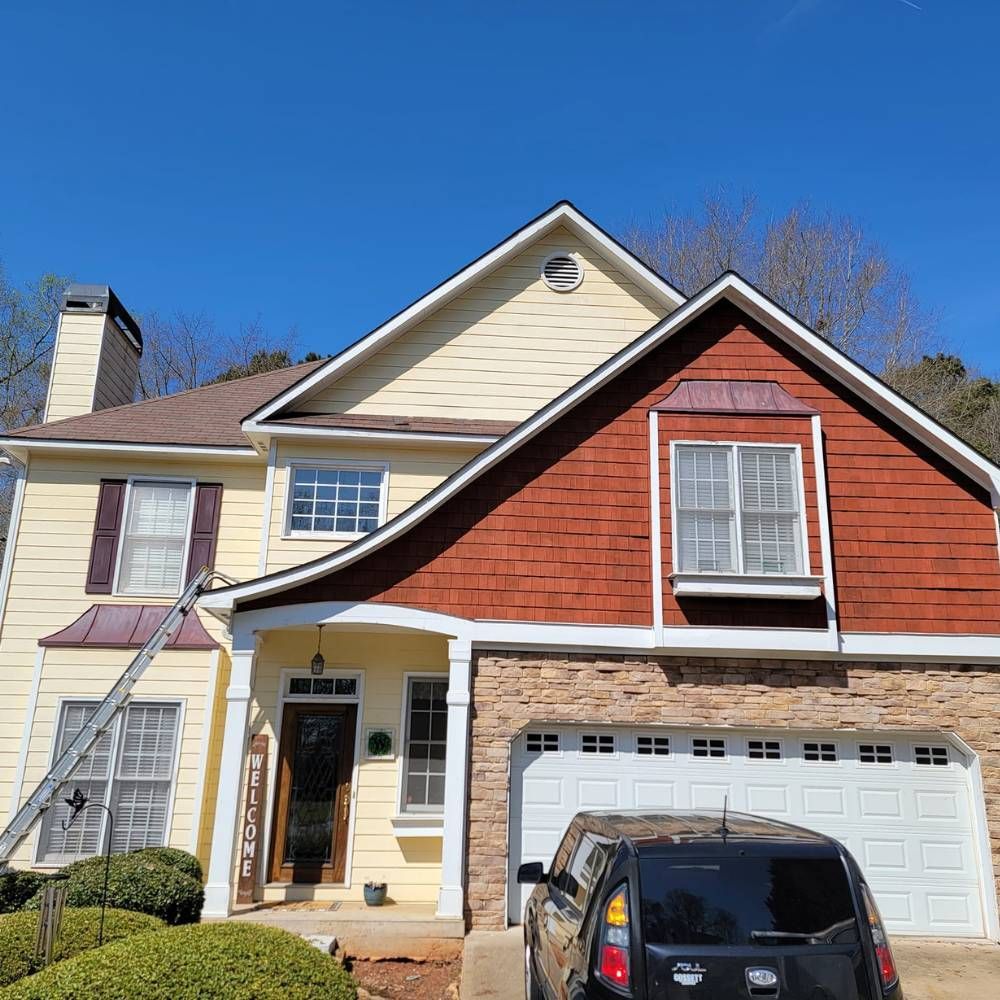 A house with a car parked in front of it.