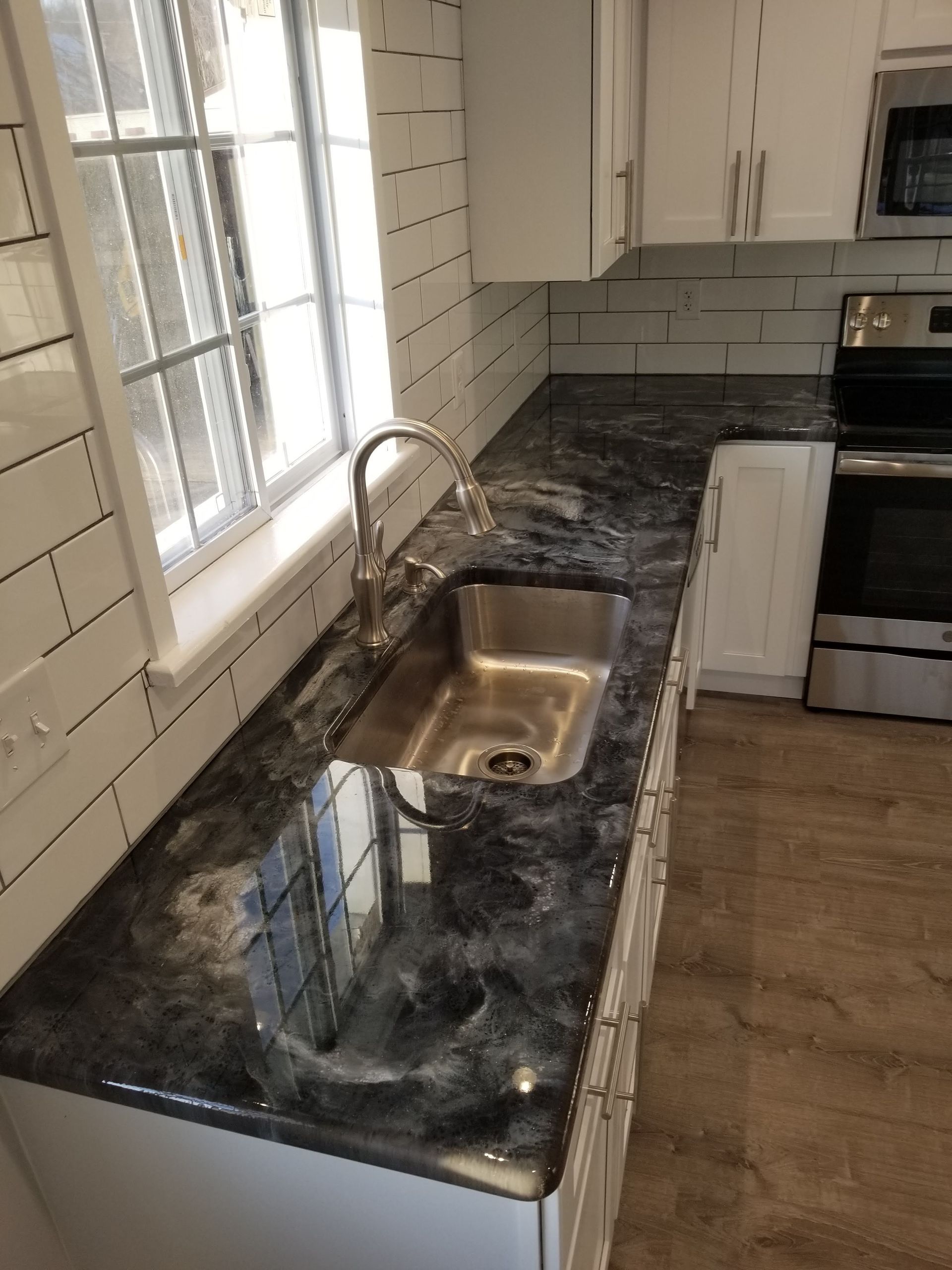 A kitchen with white cabinets and a bowl of lemons on the counter. A kitchen with white cabinets and a bowl of lemons on the counter.