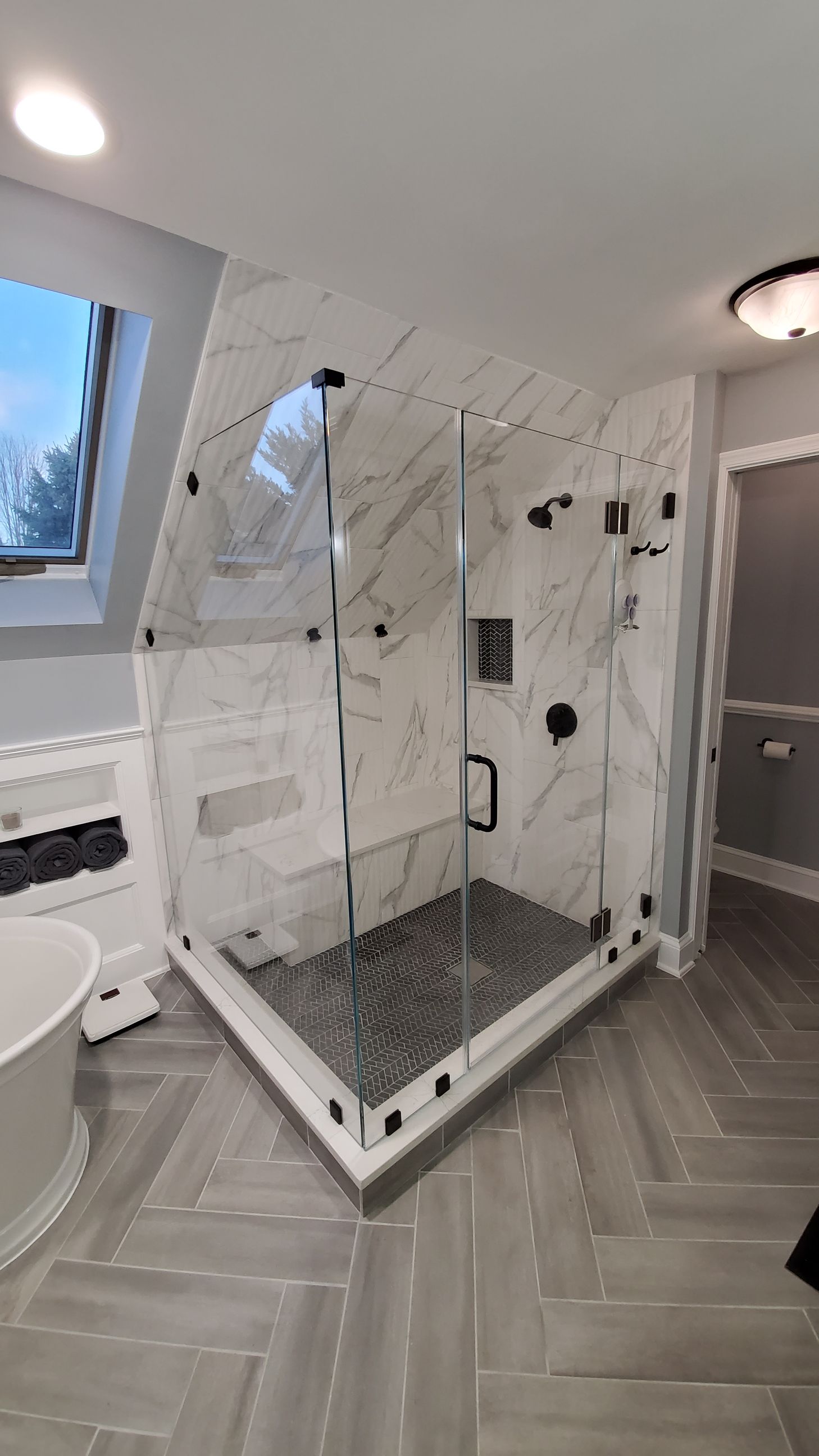 A bathroom with a toilet , sink , tub and mirror. A bathroom with a toilet , sink , tub and mirror.