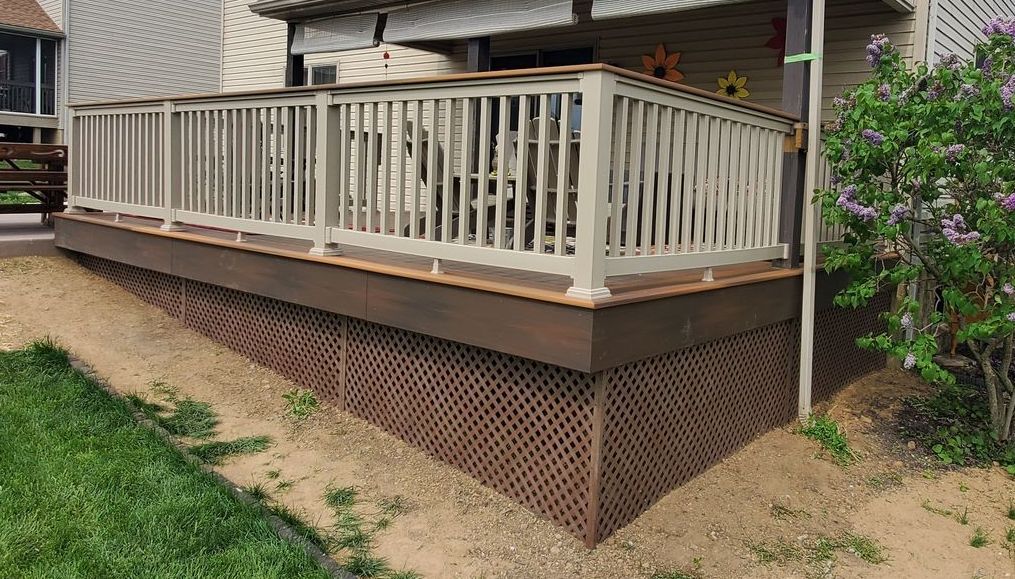 A house with a wooden deck and stairs leading to it A house with a wooden deck and stairs leading to it