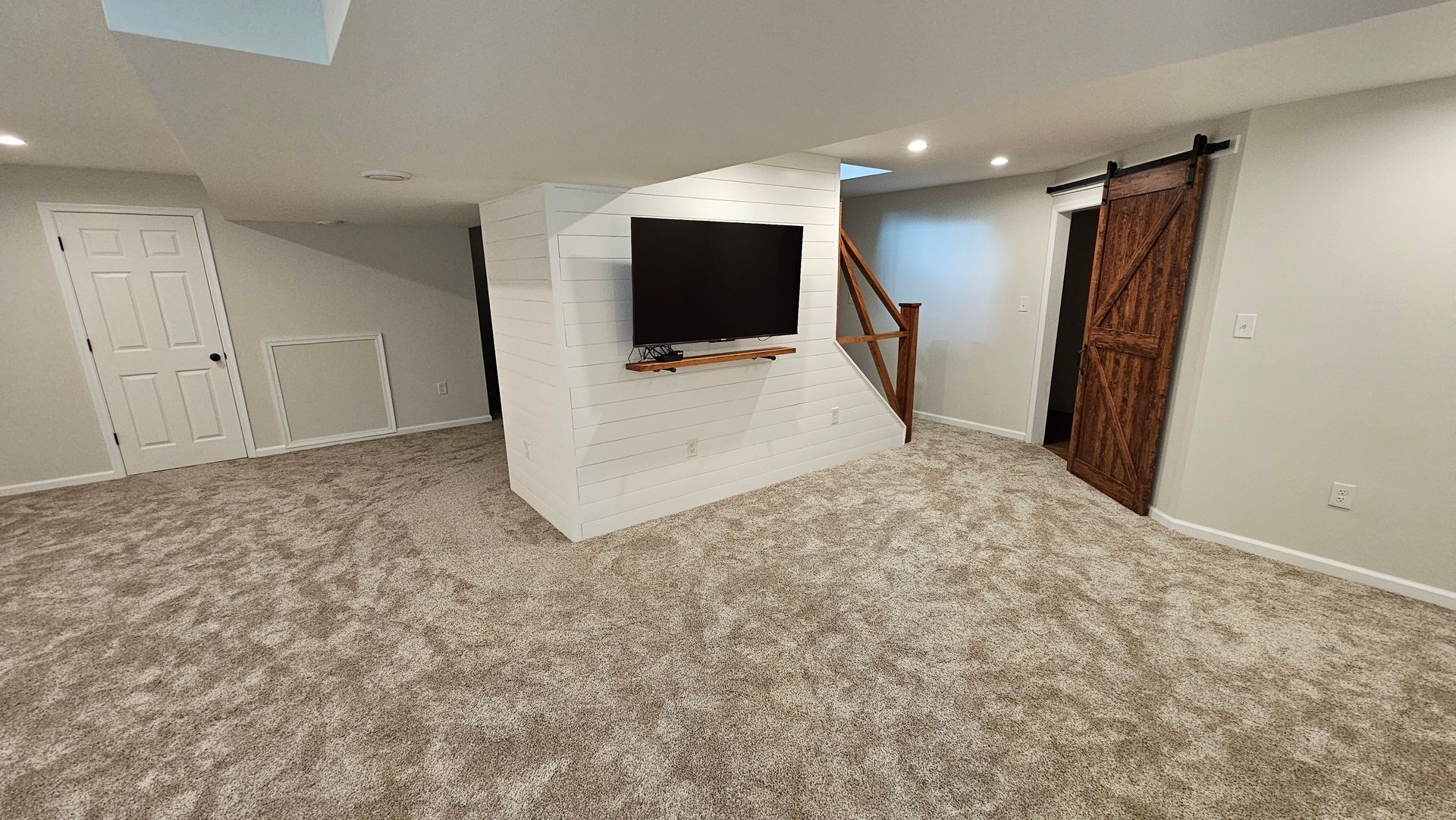 A basement with a staircase and a washer and dryer.