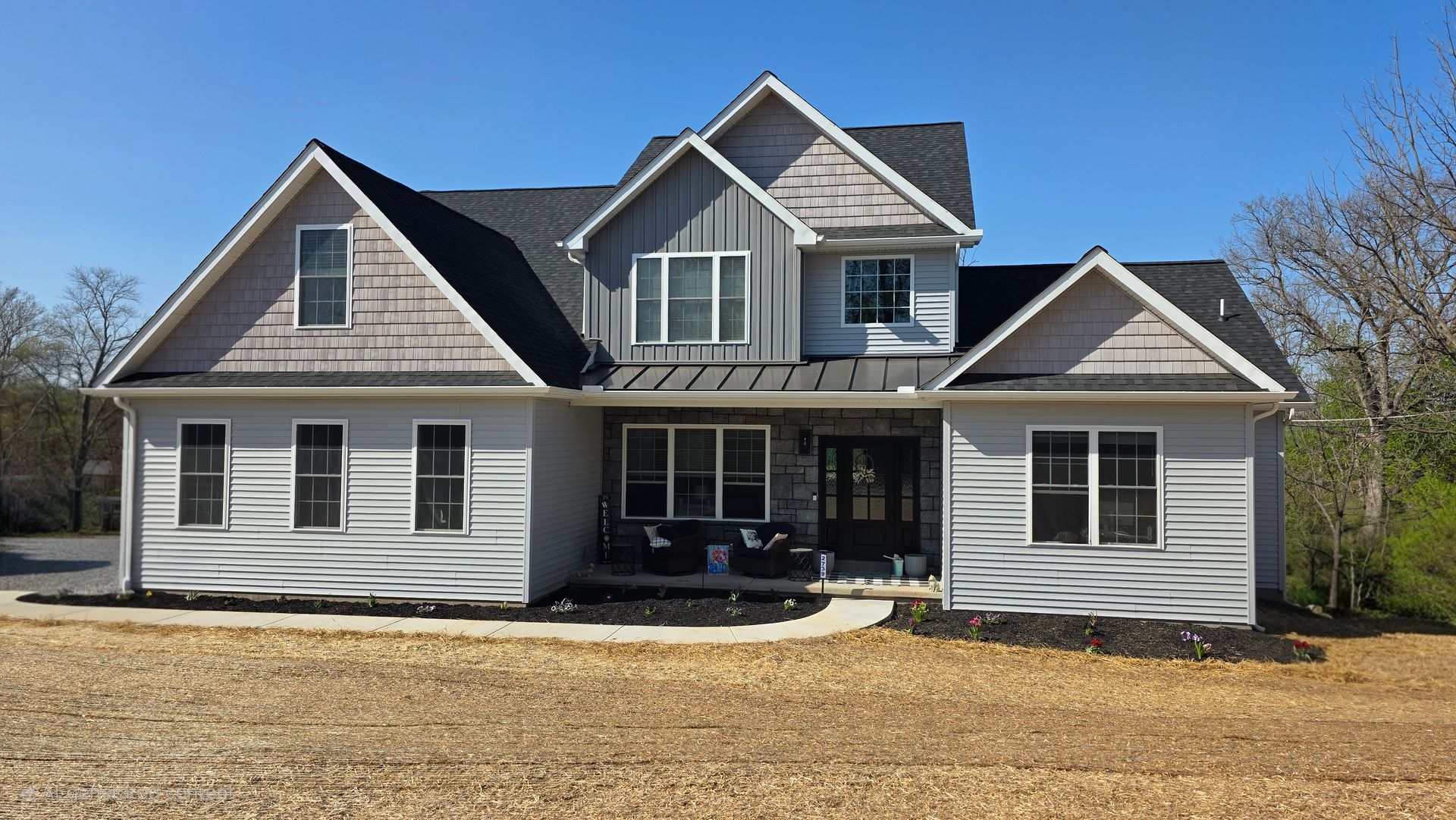 A white van is parked in front of a brick building