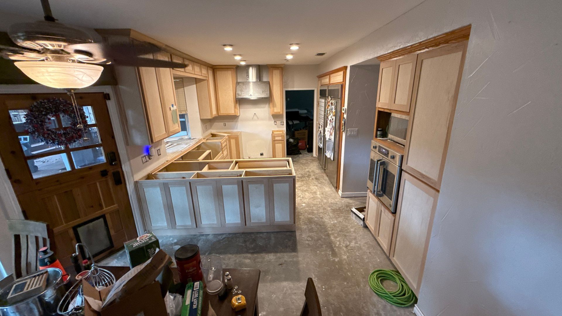 A kitchen with a lot of cabinets and appliances is being remodeled.