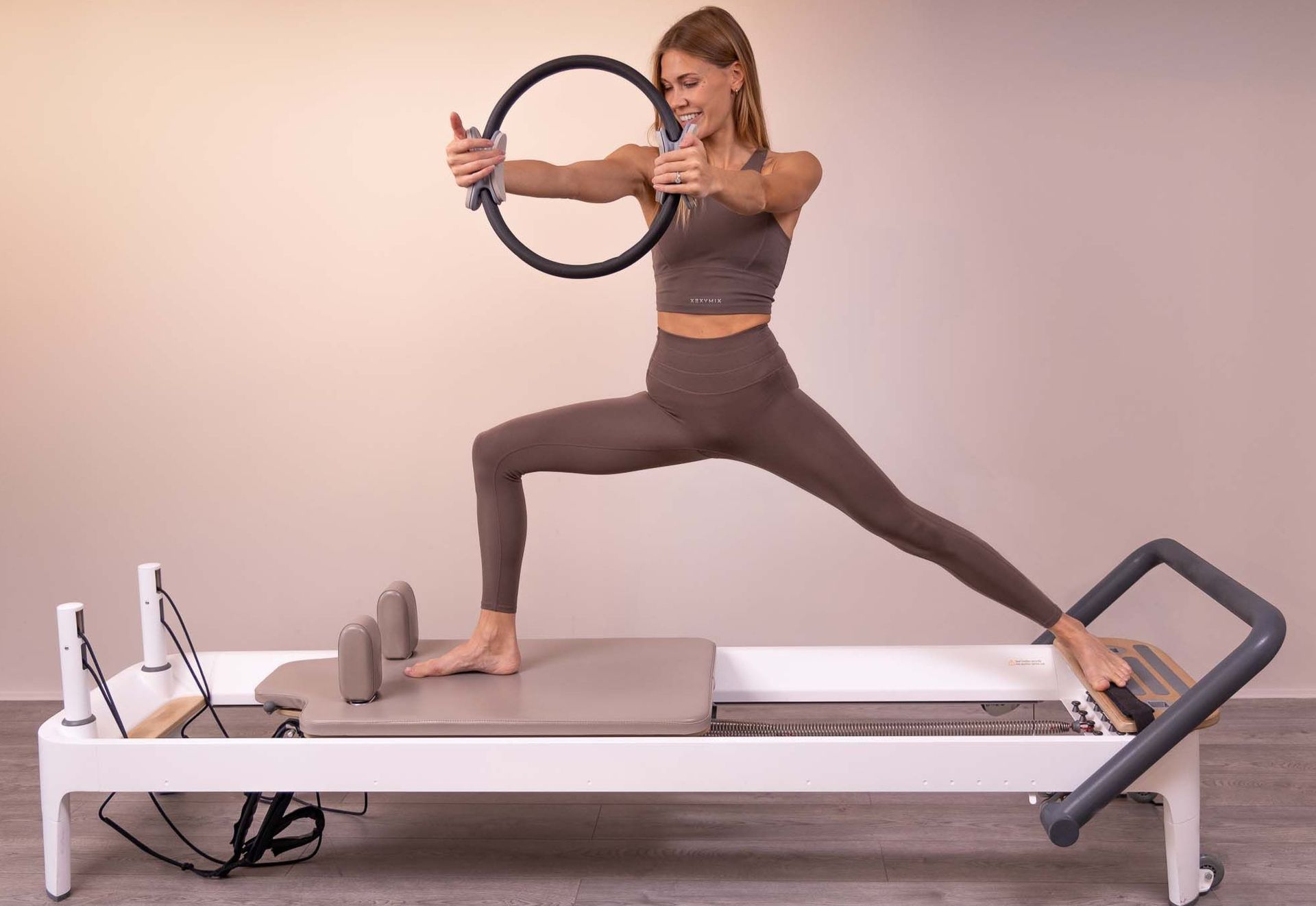 A woman is doing a handstand on a pilates machine.