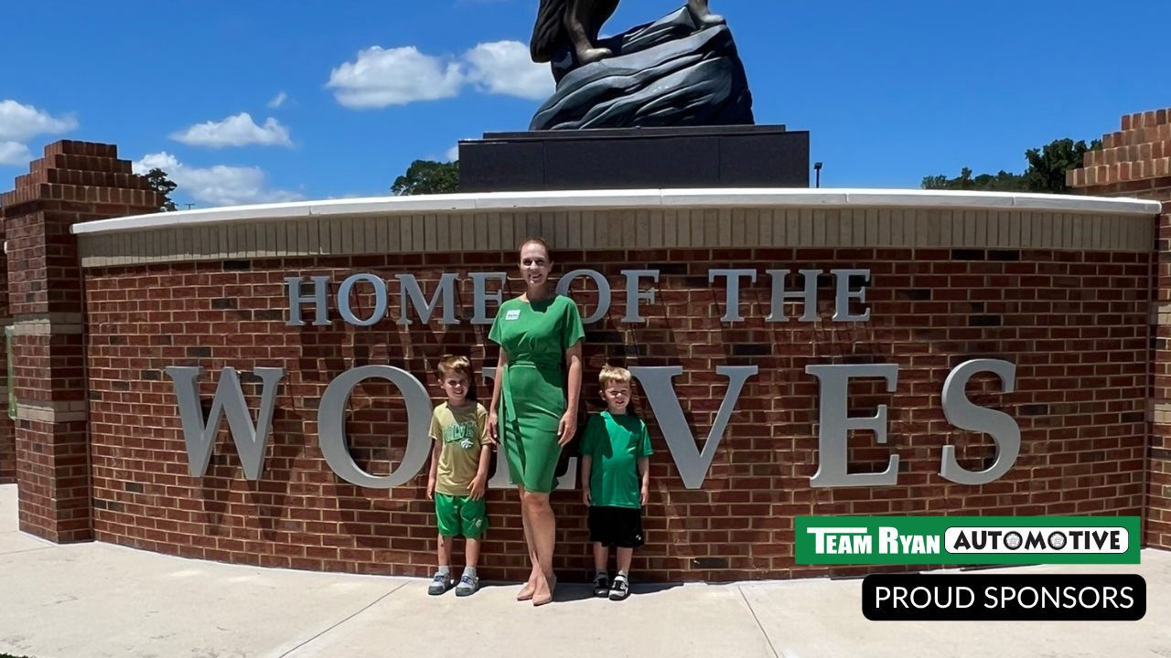 Ryan Family  in front of a brick sign that says 