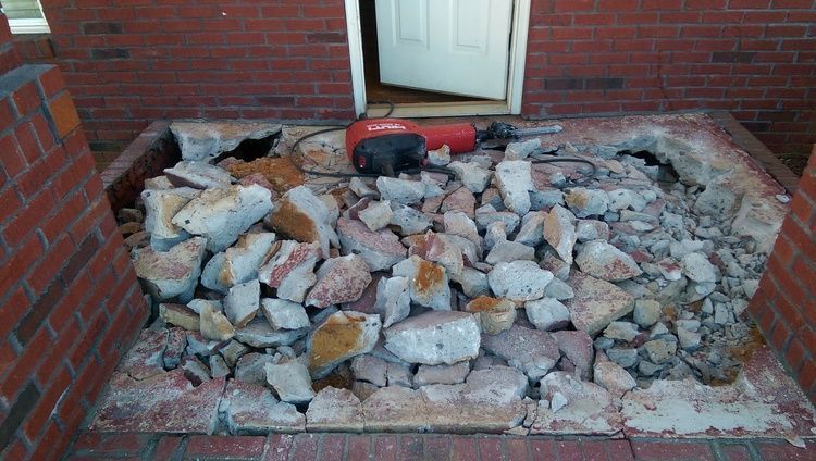 a pile of rocks is sitting in front of a brick building