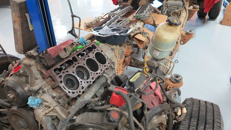 a car engine is being worked on in a garage