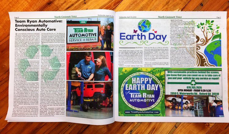 a newspaper is open to a page that says earth day