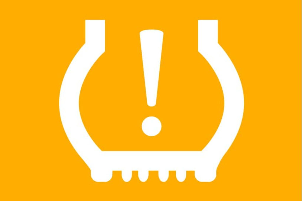 a white tire icon with an exclamation point on a yellow background