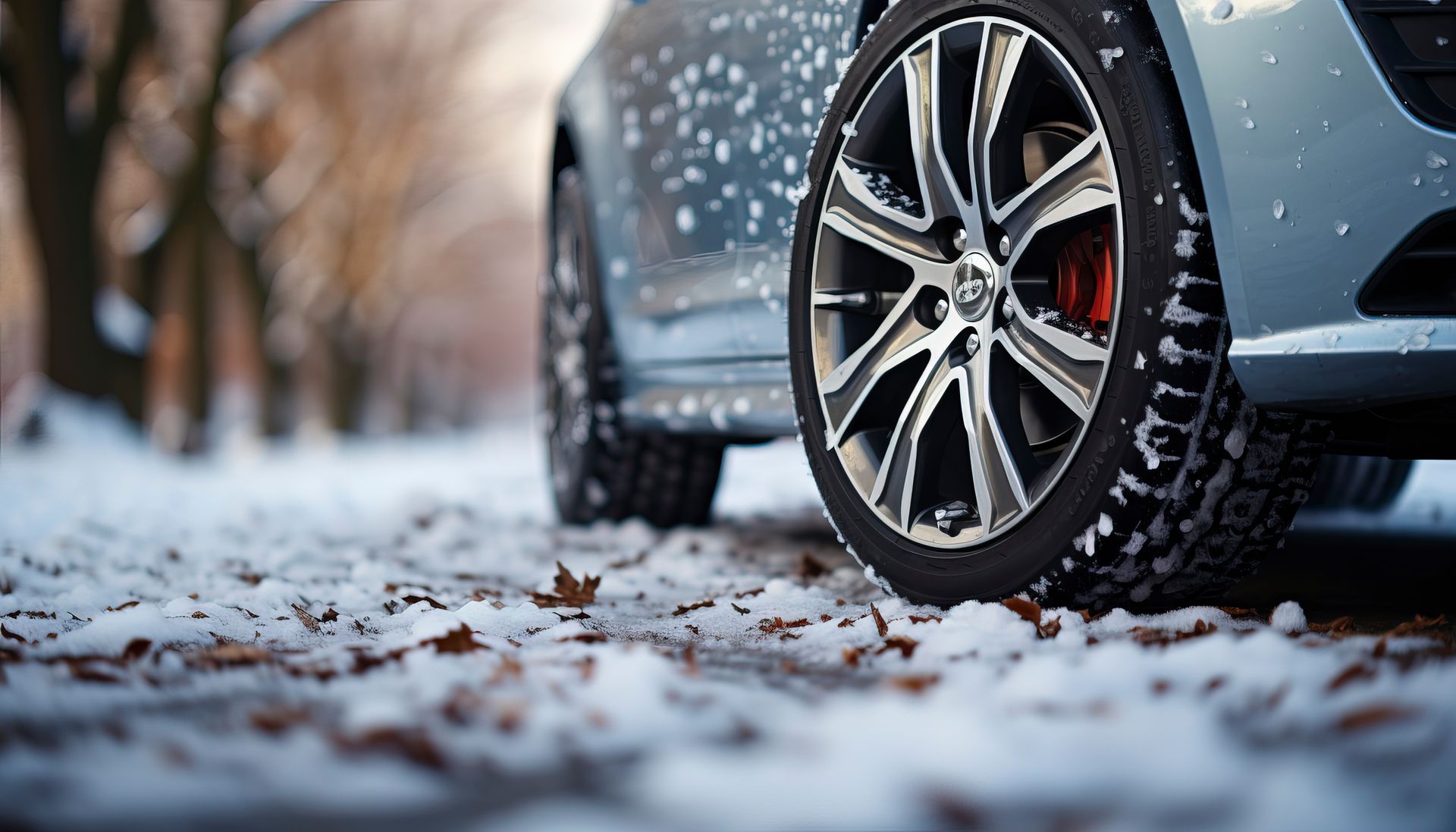 a car is parked in the snow on a snowy road .