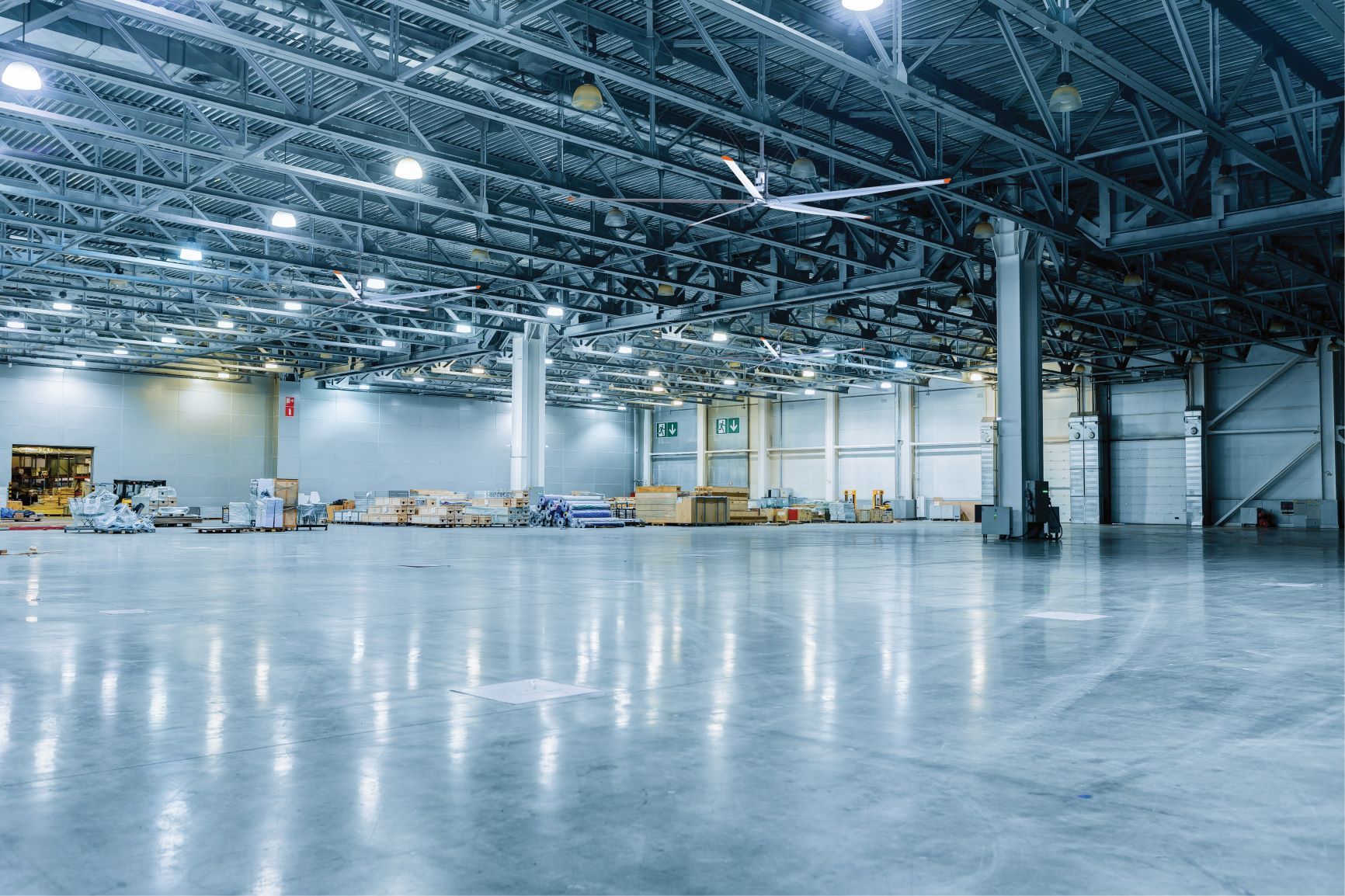 A large empty warehouse with a concrete floor and ceiling.