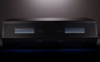 A black box with holes in it is sitting on a table.