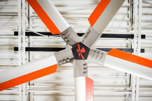 A close up of a ceiling fan with orange and white blades