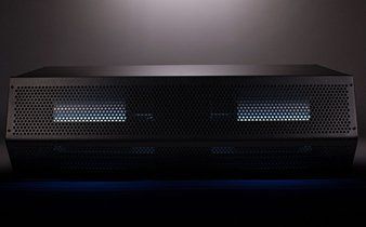 A black box with holes in it is sitting on a table.