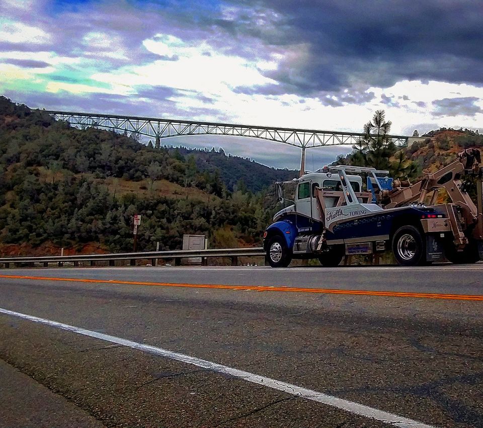 Tow truck towing a broken down car — Auburn, CA — Hall’s Towing