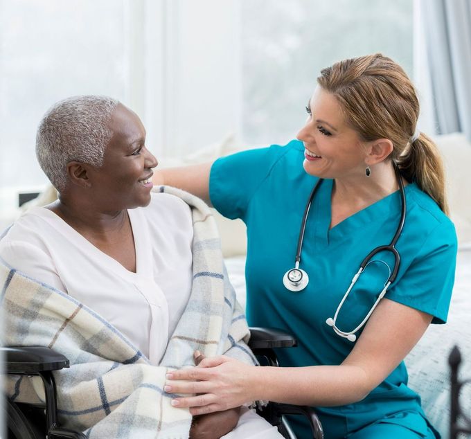 Young Female Doctor Walking With Senior Man — Bridgeton, MO — Guardian Angel Healthcare 1