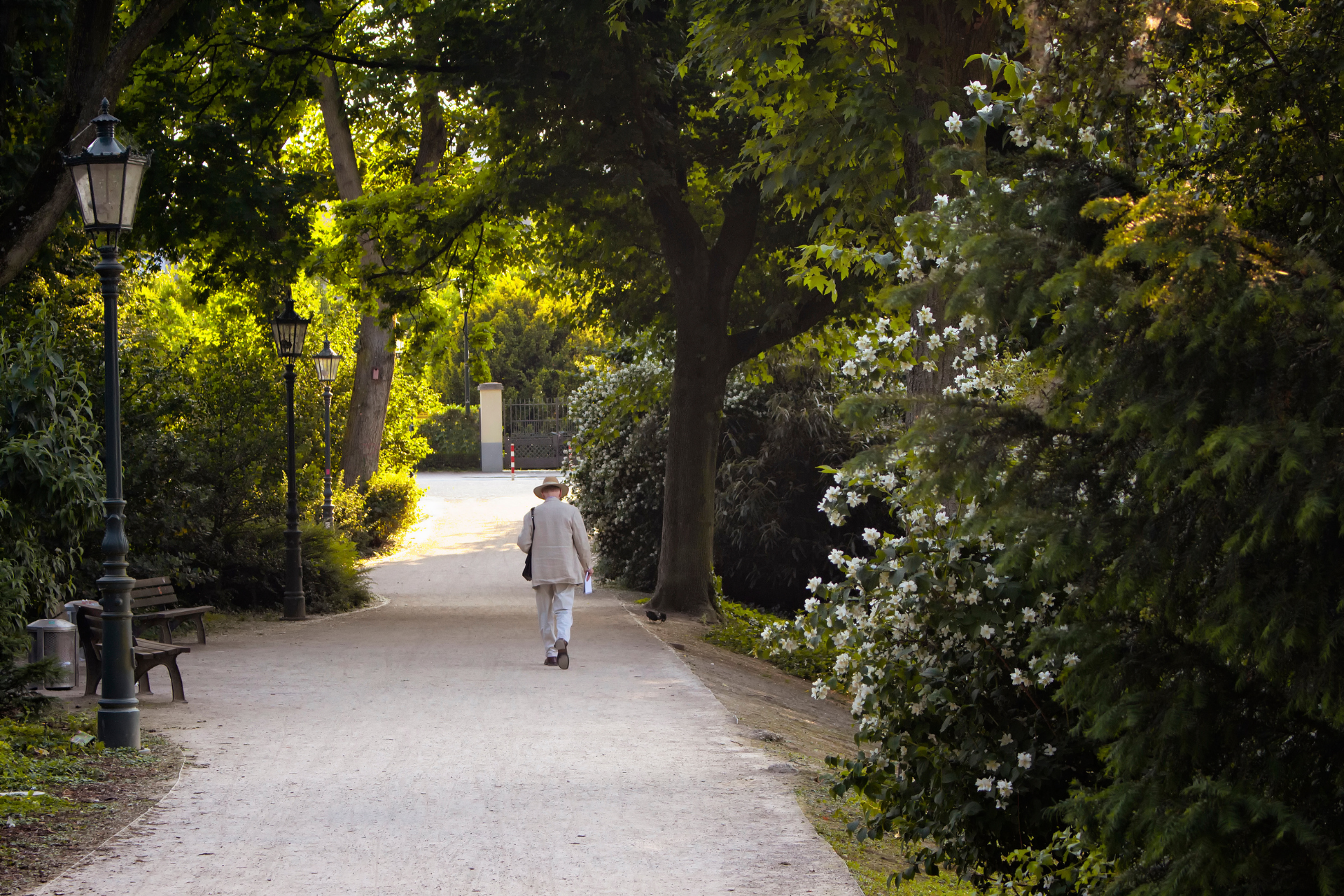 A young girl is sitting at a table with an older woman standing behind her.