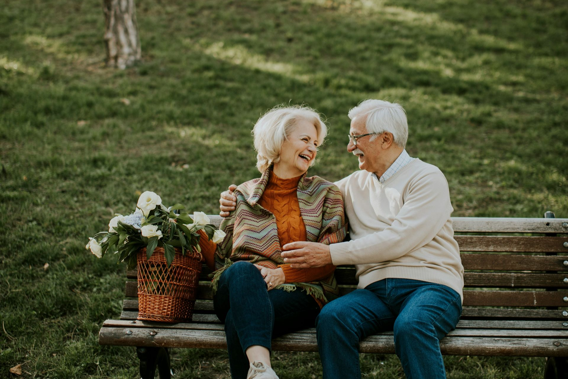 A man and woman are holding a baby and two children.